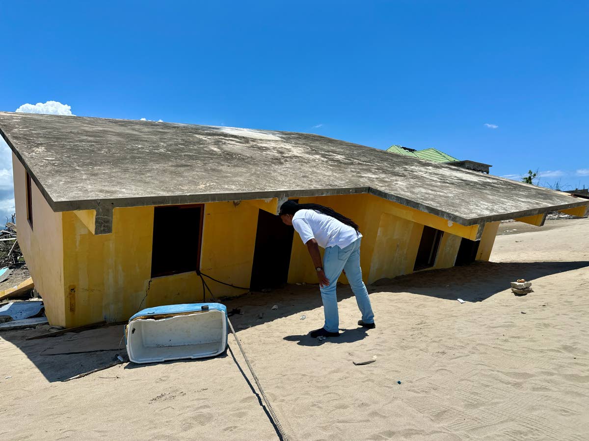 Basil Bennett’s peeks into his house that was toppled during the passage of Hurricane Melissa in Parottee, St Elizabeth.