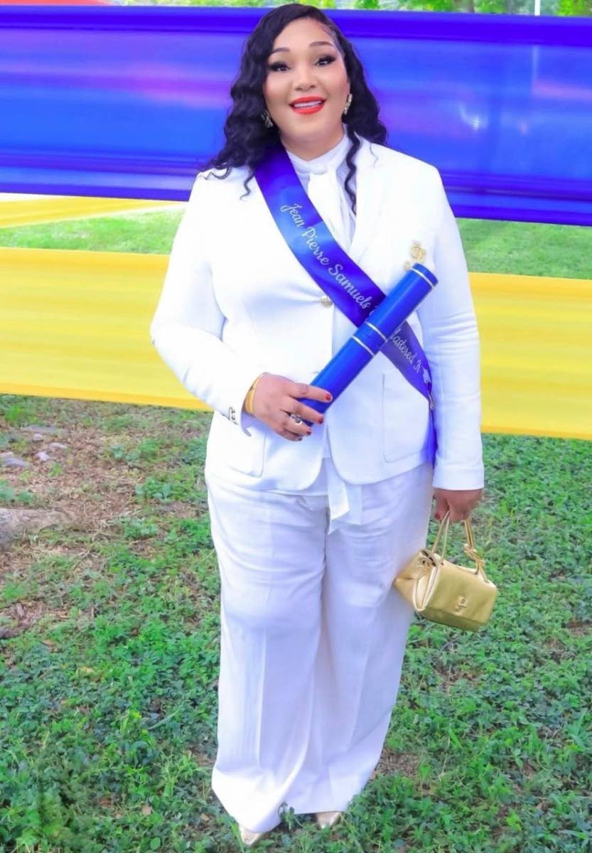 Trecha Thomas poses with her son Jean-Pierre Samuels’ master’s degree, which she collected at his graduation ceremony a few weeks after his death.