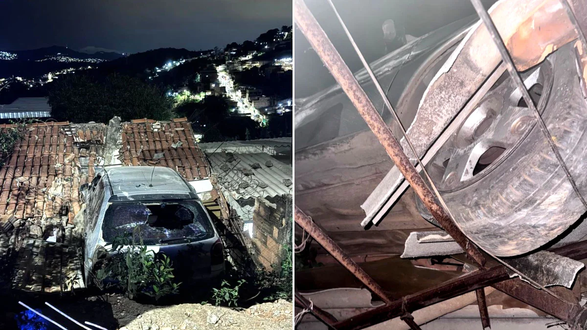 Carro bate em muro e fica "pendurado" sobre telhado de casa em BH