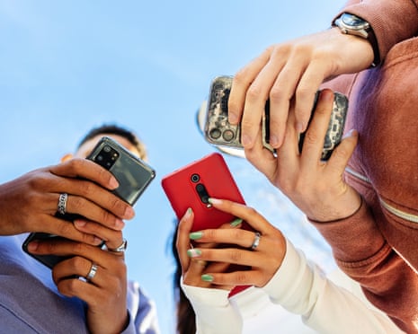 Three people looking at their phones.