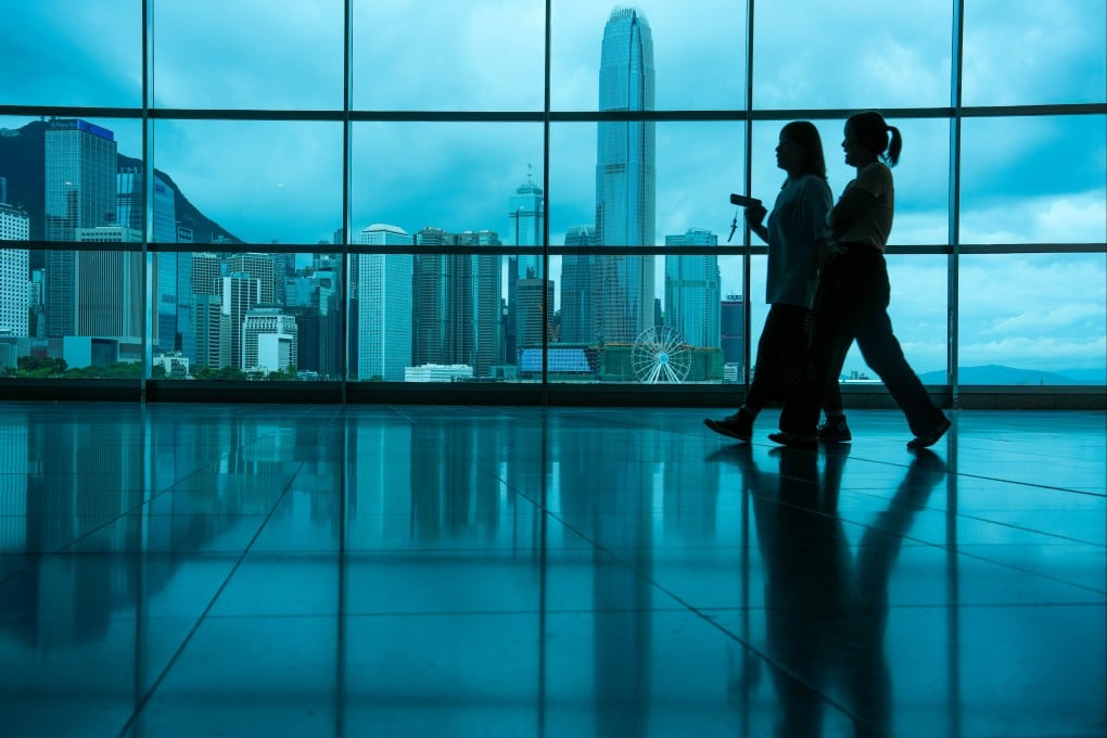 Visitors walk inside Hong Kong Convention and Exhibition Centre in Wan Chai with Victoria Harbour in the background on June 8. Photo: Sam Tsang