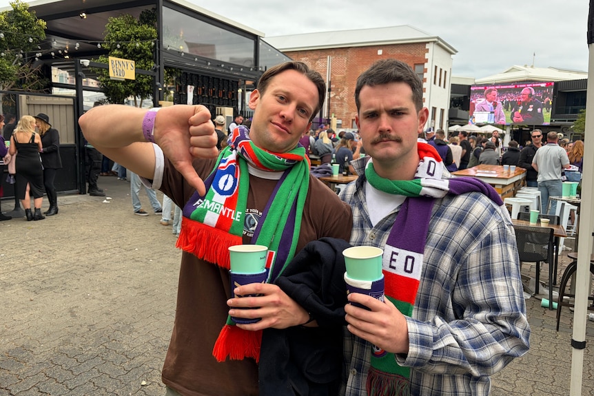 Two Freo fans with an upset look.