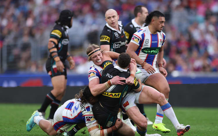 SYDNEY, AUSTRALIA - SEPTEMBER 27: Nathan Cleary of the Panthers is tackled by Phoenix Crossland of the Knights during the NRL Preliminary Final match between the Penrith Panthers and Newcastle Knights at Accor Stadium on September 27, 2026, in Sydney, Australia. (Photo by Darrian Traynor/Getty Images)