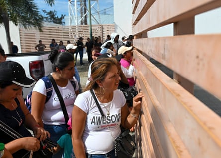 People near wood fencing