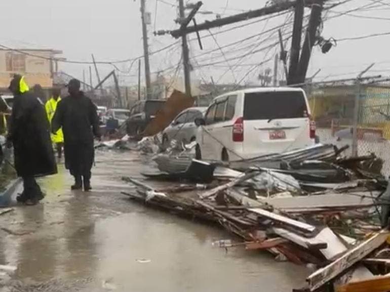 Police personnel survey the damage done to Black River in St Elizabeth following the passage of Hurricane Melissa last October.