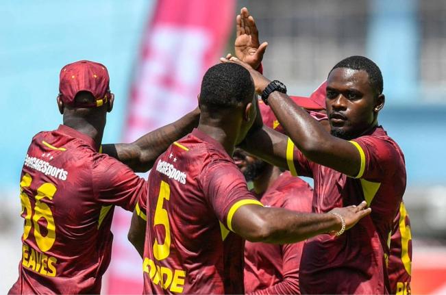 West Indies players celebrate the fall of a wicket during a recent match.