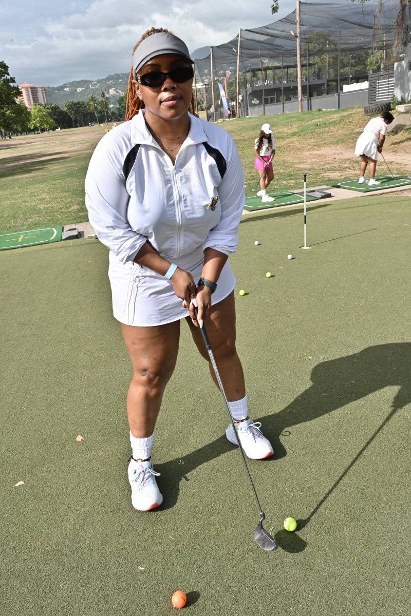 Customs Broker Cassandra Gordon keeps it cool in an all-white athletic look, pairing a collared long-sleeved top with matching shorts, a white visor, crew socks, sneakers, and dark shades.