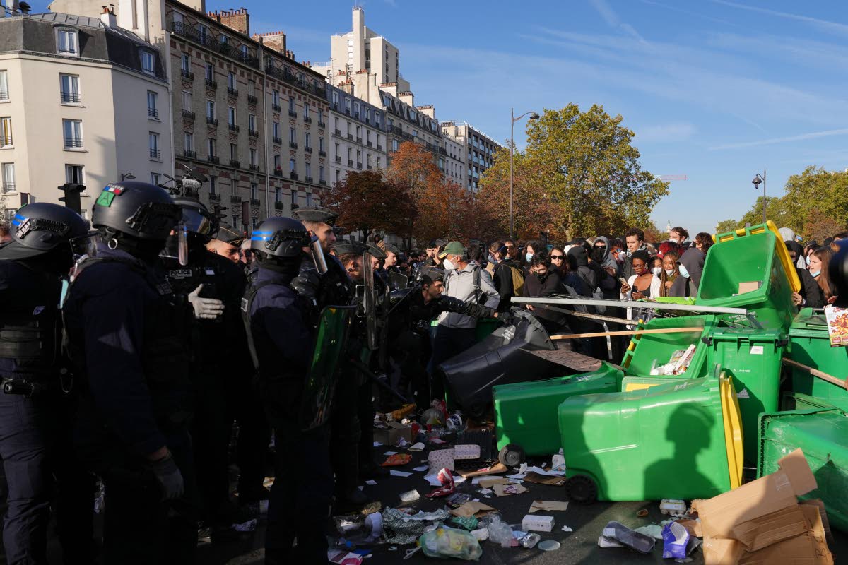 Riot police face high school students as they gather before a demonstration against under-resourced schools in Paris, Tuesday, Oct. 6, 2026. (AP Photo/Aurelien Morissard)